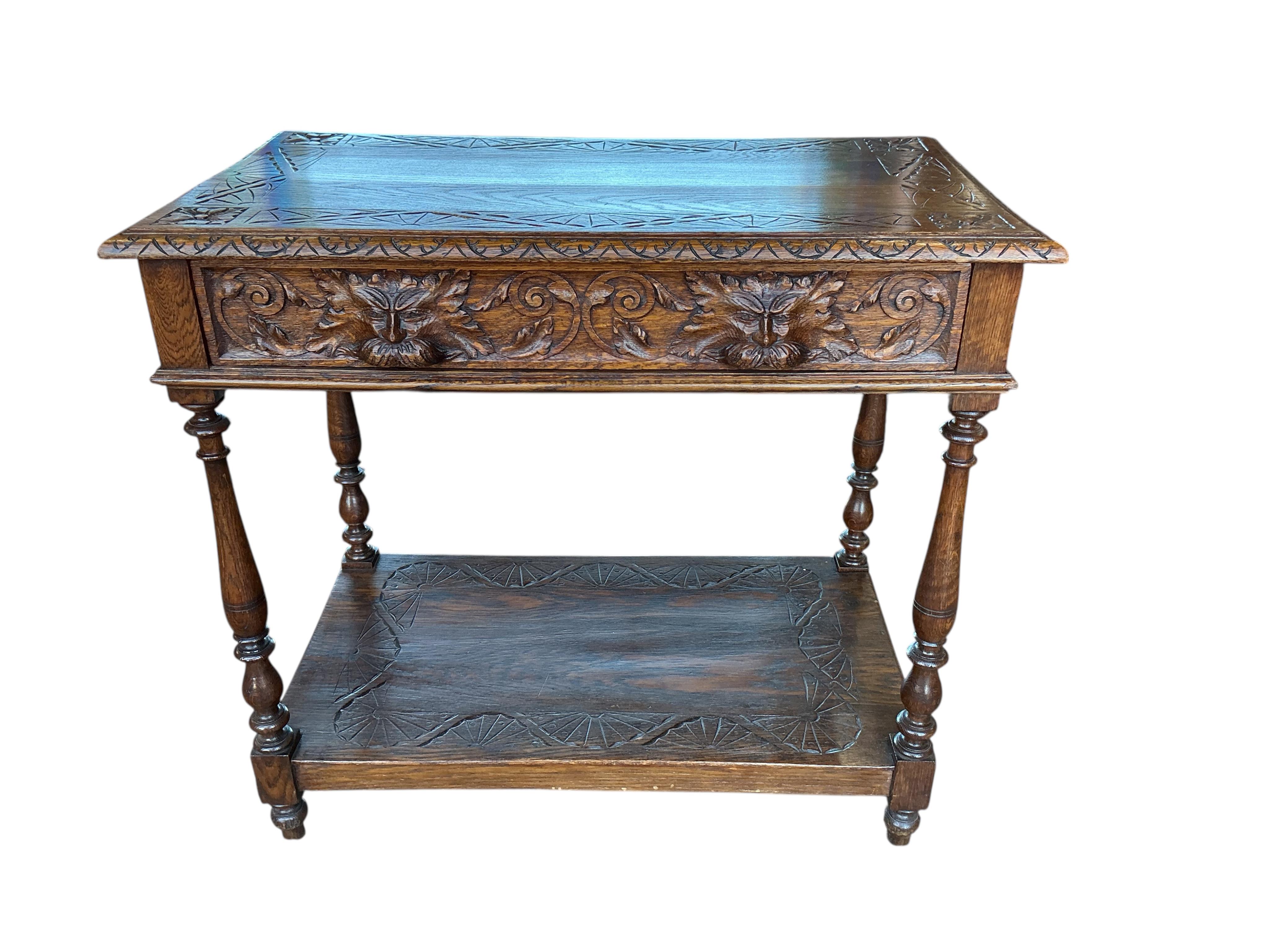 A late Victorian Flemish carved oak two tier table, width 84cm, depth 49cm, height 75cm